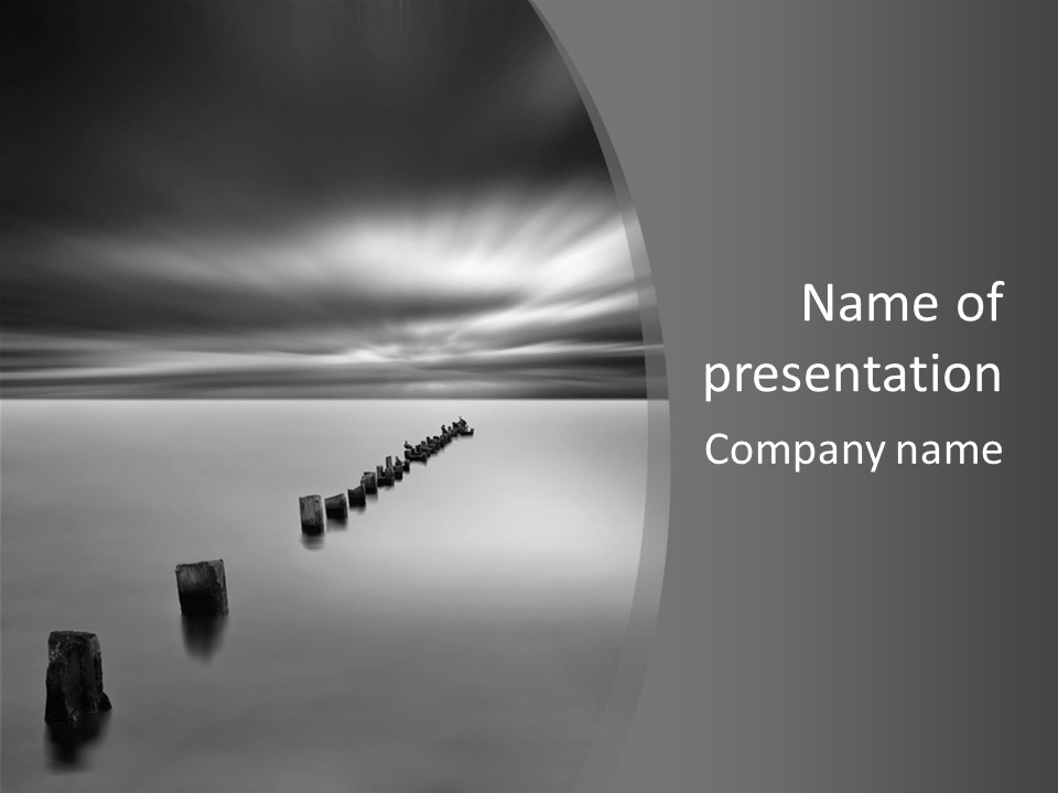 A Black And White Photo Of A Dock In The Ocean PowerPoint Template