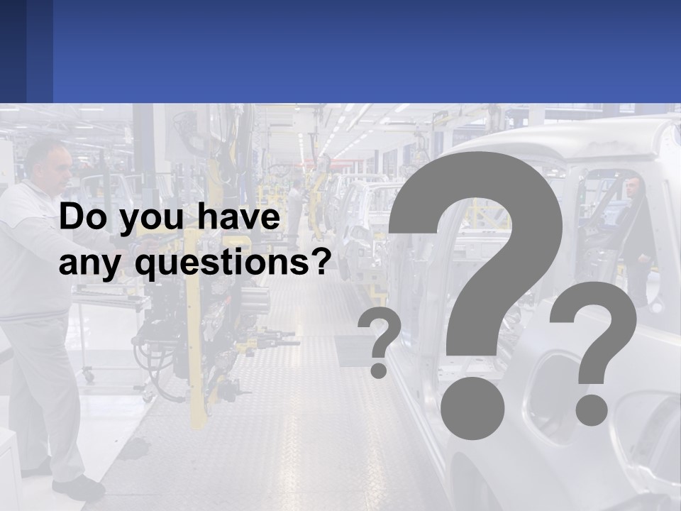 A Man Is Working On A Car In A Factory PowerPoint Template