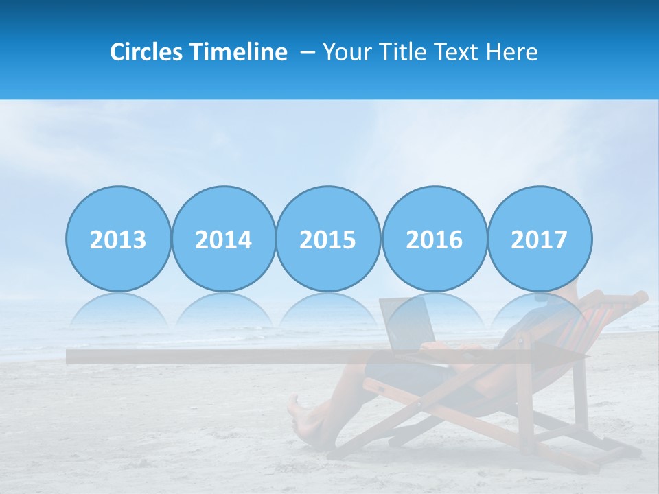 A Man Sitting In A Chair On A Beach Using A Laptop PowerPoint Template