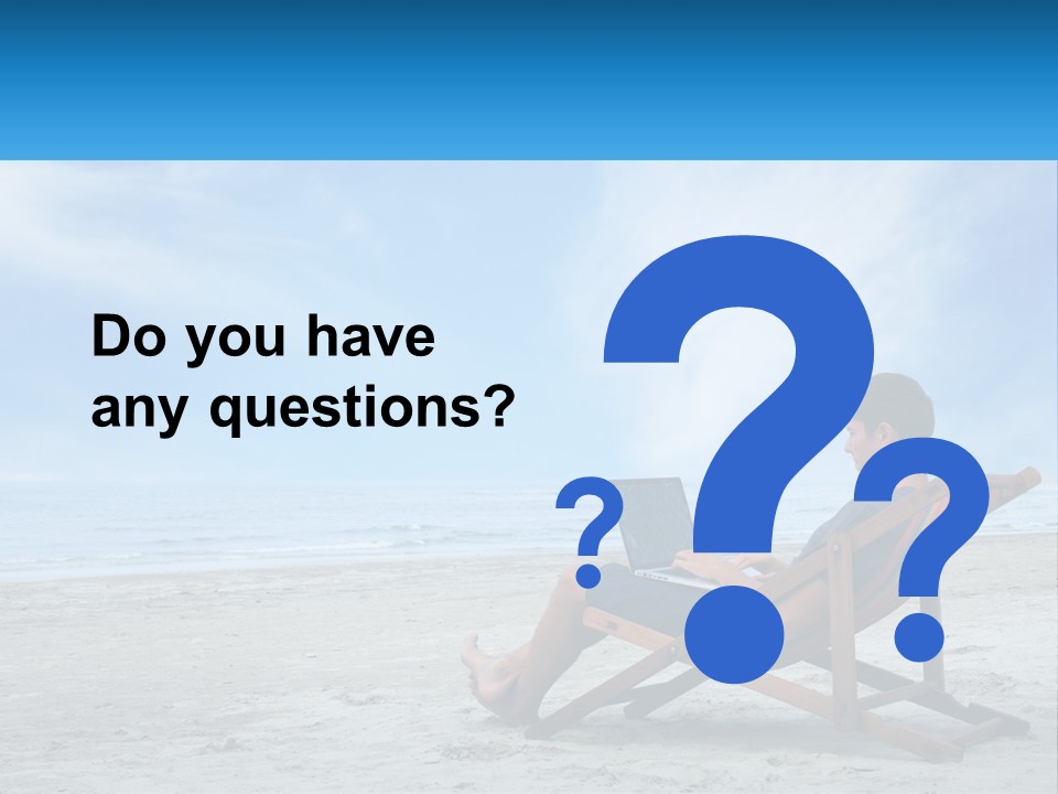 A Man Sitting In A Chair On A Beach Using A Laptop PowerPoint Template