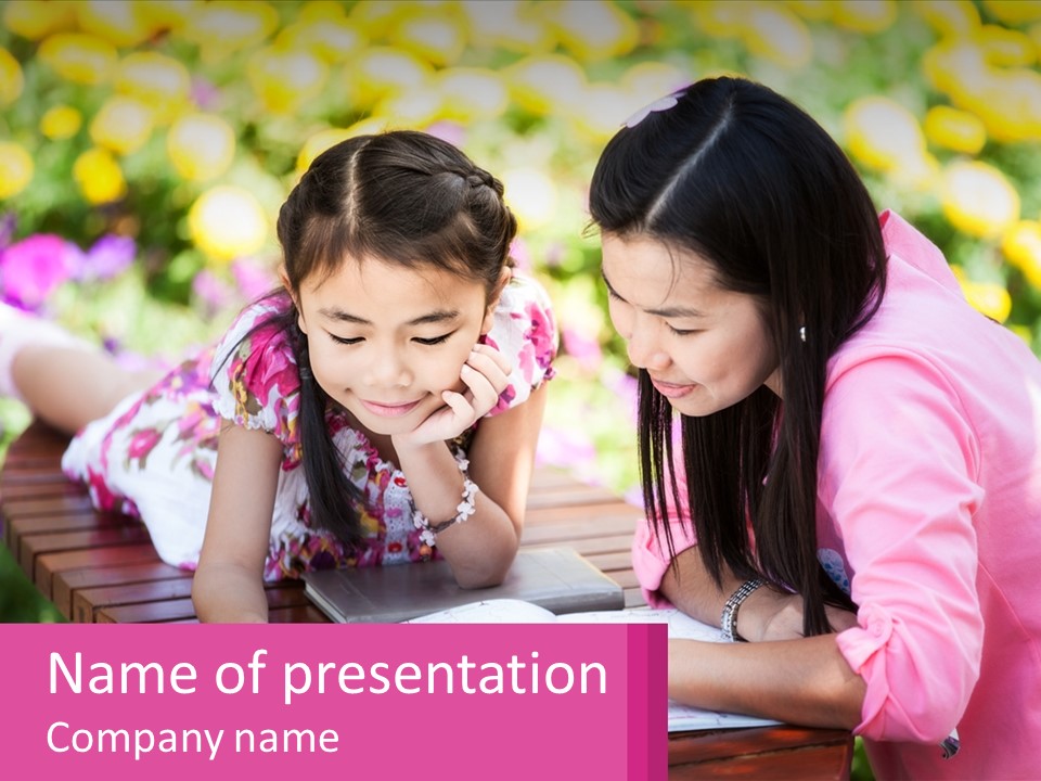 Two Girls Are Looking At A Book On A Bench PowerPoint Template