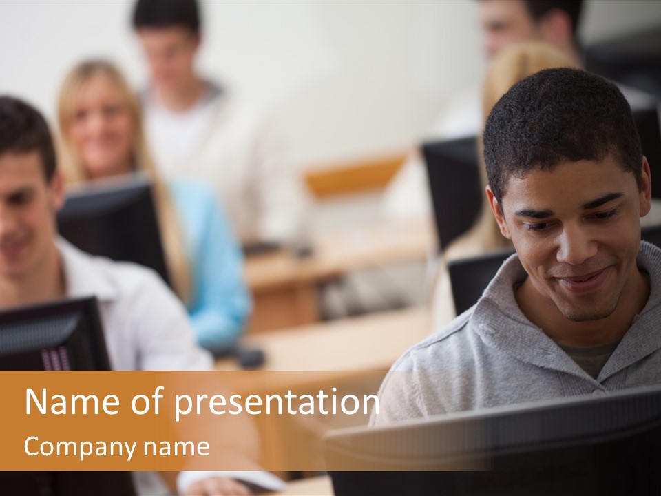 A Group Of People Working On Computers In A Classroom PowerPoint Template