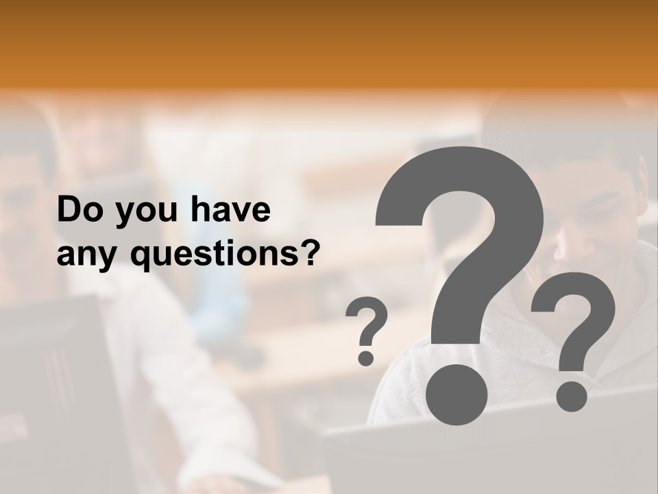 A Group Of People Working On Computers In A Classroom PowerPoint Template