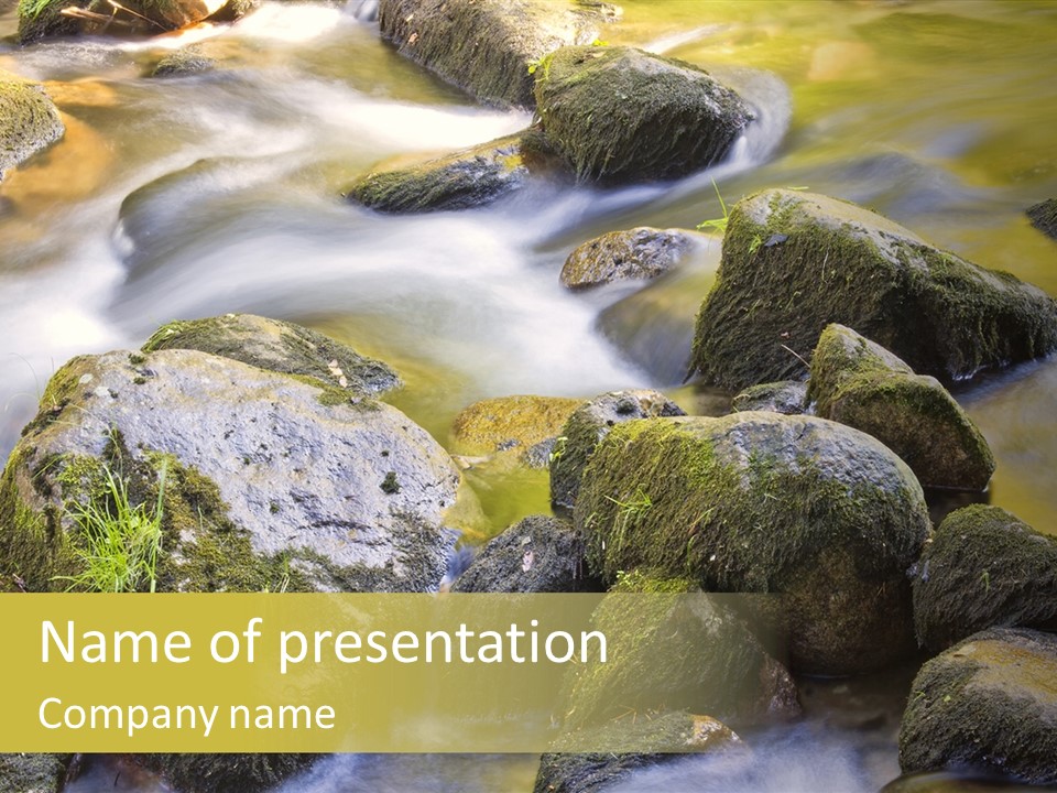 A Stream Of Water Surrounded By Rocks And Grass PowerPoint Template