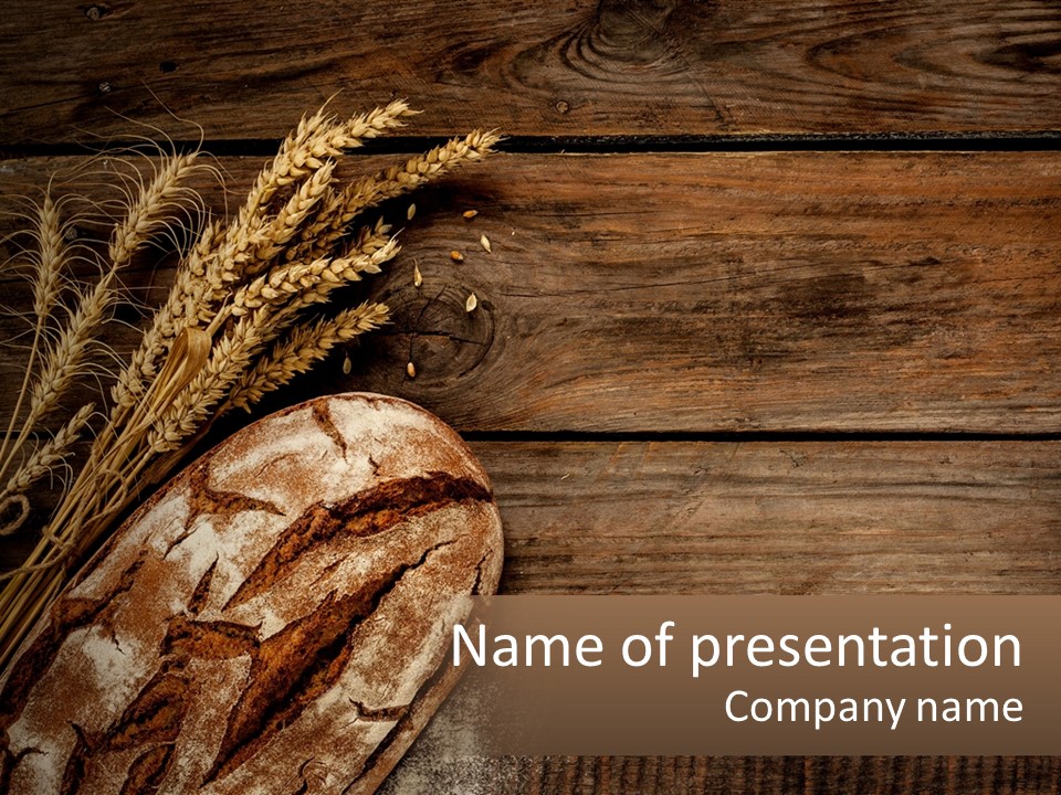 A Loaf Of Bread And Some Wheat On A Wooden Table PowerPoint Template