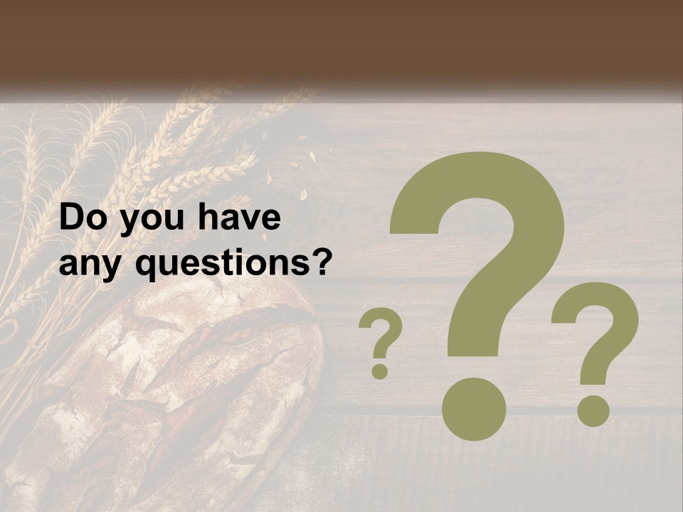 A Loaf Of Bread And Some Wheat On A Wooden Table PowerPoint Template