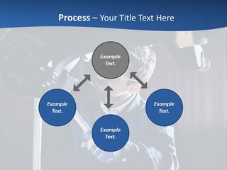 A Man Working On A Car In A Garage PowerPoint Template