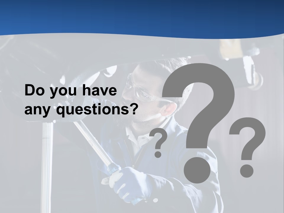 A Man Working On A Car In A Garage PowerPoint Template