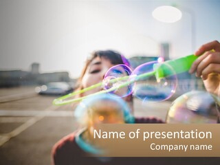 A Young Girl Blowing Bubbles With Her Hands PowerPoint Template