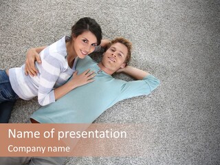 A Man And A Woman Laying On The Floor With Their Arms Around Each Other PowerPoint Template