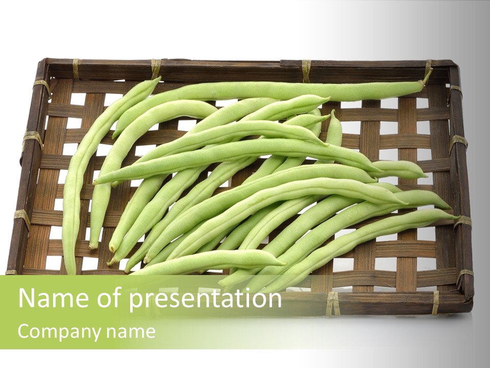 A Wooden Crate Filled With Green Beans On Top Of A Table PowerPoint Template