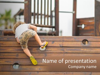 A Young Child Climbing Up A Wooden Slide PowerPoint Template