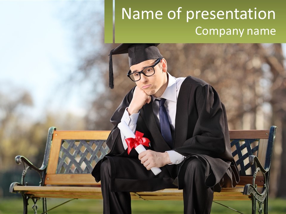 A Man In A Graduation Gown Sitting On A Bench PowerPoint Template