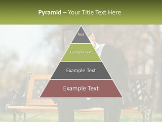 A Man In A Graduation Gown Sitting On A Bench PowerPoint Template