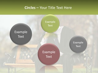 A Man In A Graduation Gown Sitting On A Bench PowerPoint Template