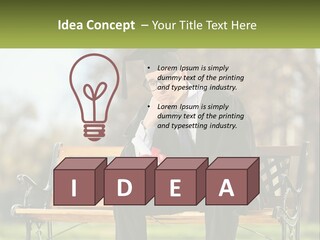 A Man In A Graduation Gown Sitting On A Bench PowerPoint Template