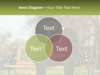 A Man In A Graduation Gown Sitting On A Bench PowerPoint Template