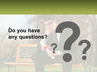 A Man In A Graduation Gown Sitting On A Bench PowerPoint Template