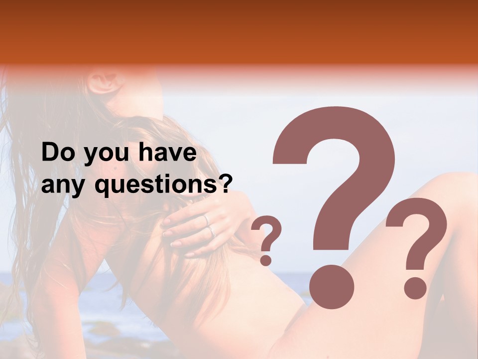 A Woman Is Sitting On The Beach With Her Hair Blowing In The Wind PowerPoint Template