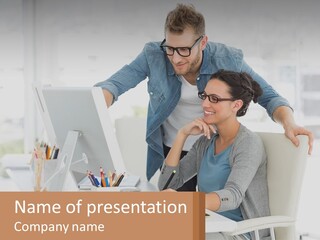 A Man And A Woman Sitting At A Desk Looking At A Computer Screen PowerPoint Template