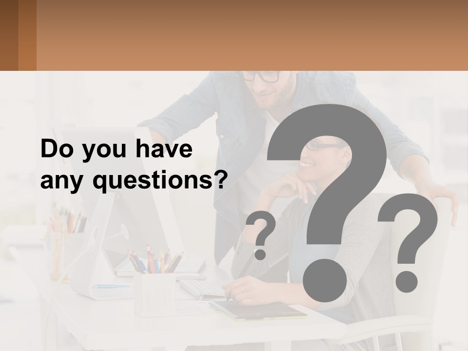 A Man And A Woman Sitting At A Desk Looking At A Computer Screen PowerPoint Template