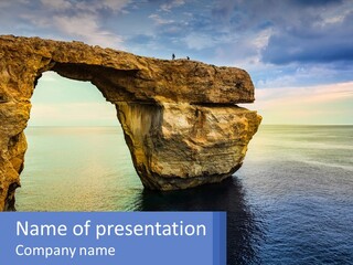 A Large Rock Formation In The Middle Of A Body Of Water PowerPoint Template