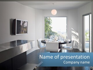 A Table And Chairs In A Room With A Large Window PowerPoint Template