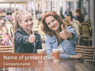 Two Girls Giving Thumbs Up At A Table PowerPoint Template