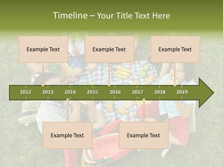 A Group Of Children Sitting On A Blanket Eating Food PowerPoint Template