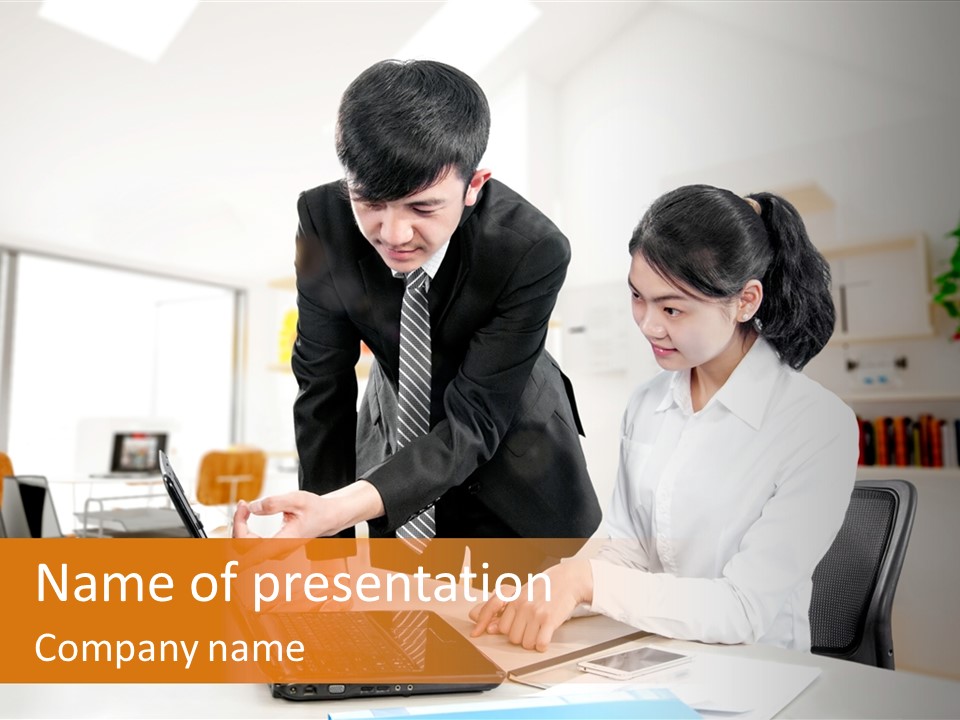 A Couple Of People That Are Looking At A Laptop PowerPoint Template