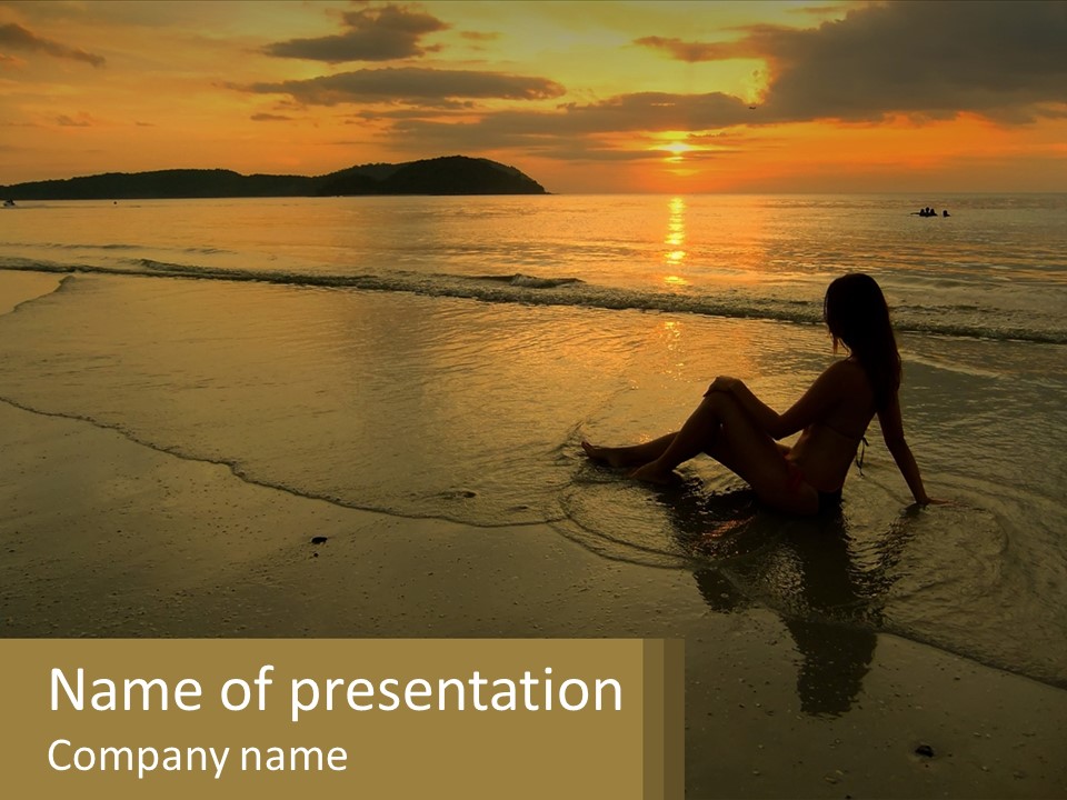 A Woman Is Sitting On The Beach At Sunset PowerPoint Template