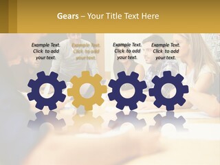 A Group Of People Sitting Around A Conference Table PowerPoint Template