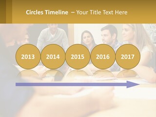 A Group Of People Sitting Around A Conference Table PowerPoint Template