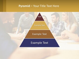 A Group Of People Sitting Around A Conference Table PowerPoint Template