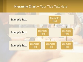 A Group Of People Sitting Around A Conference Table PowerPoint Template