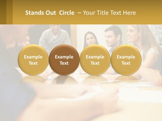 A Group Of People Sitting Around A Conference Table PowerPoint Template