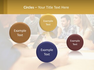 A Group Of People Sitting Around A Conference Table PowerPoint Template