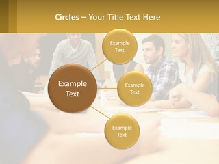 A Group Of People Sitting Around A Conference Table PowerPoint Template