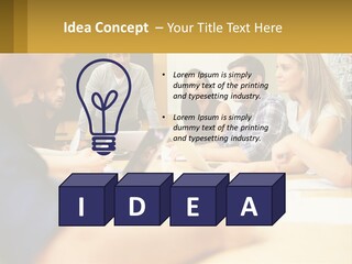 A Group Of People Sitting Around A Conference Table PowerPoint Template