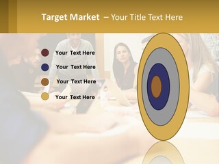 A Group Of People Sitting Around A Conference Table PowerPoint Template