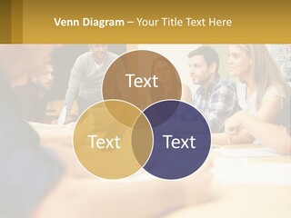 A Group Of People Sitting Around A Conference Table PowerPoint Template