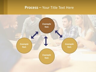 A Group Of People Sitting Around A Conference Table PowerPoint Template