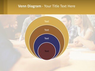 A Group Of People Sitting Around A Conference Table PowerPoint Template