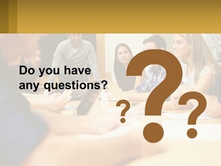 A Group Of People Sitting Around A Conference Table PowerPoint Template