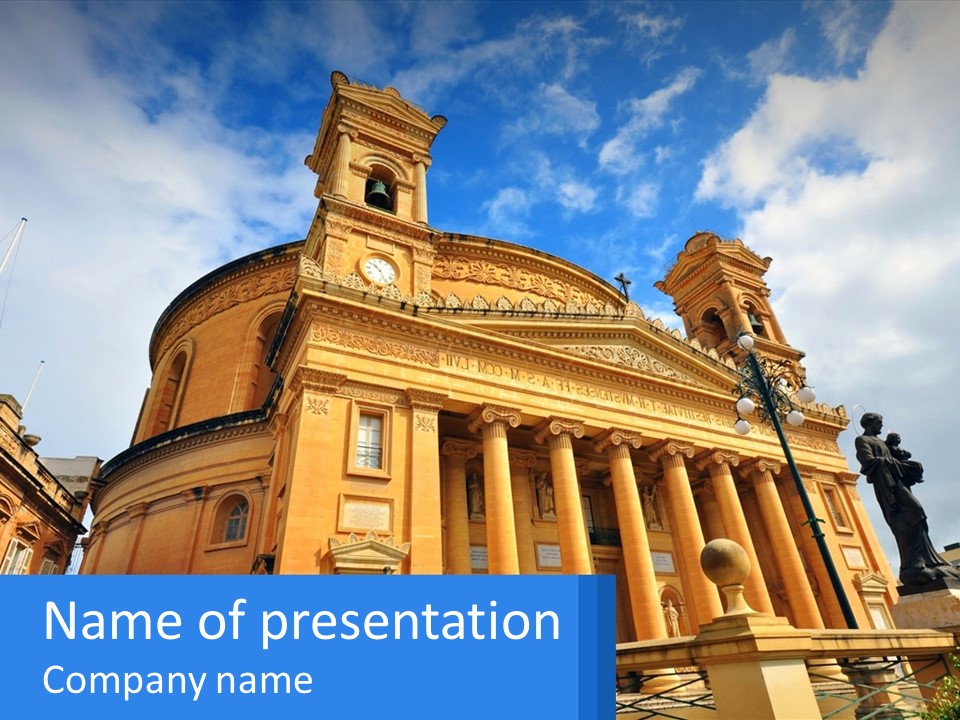 A Large Building With Columns And A Clock On It PowerPoint Template