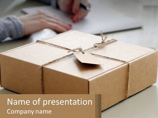 A Person Writing On A Piece Of Paper Next To A Wrapped Present Box PowerPoint Template