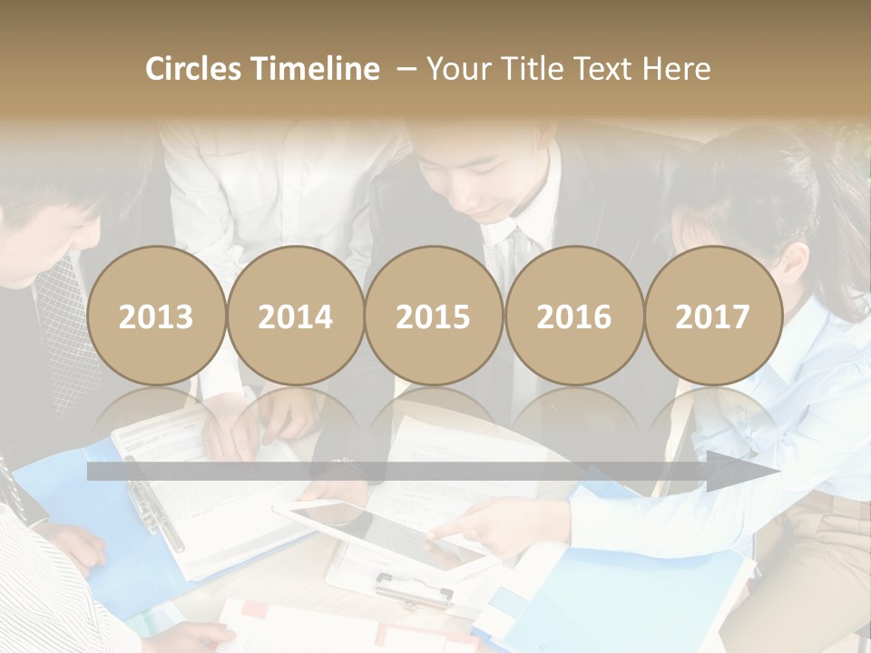 A Group Of People Sitting Around A Table With Papers PowerPoint Template