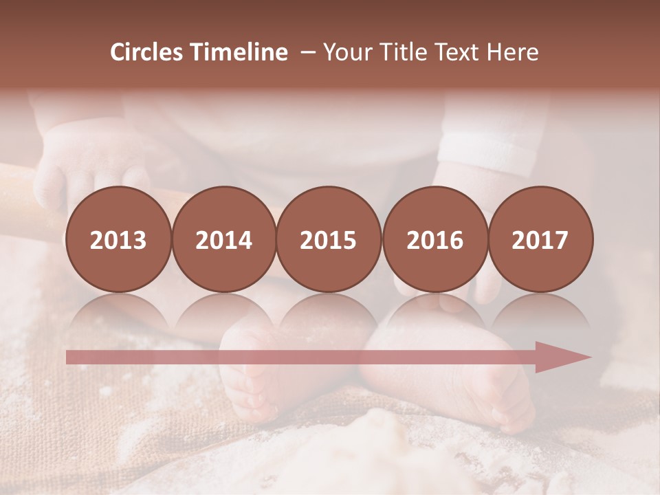 A Baby Holding A Rolling Pin On Top Of A Table PowerPoint Template