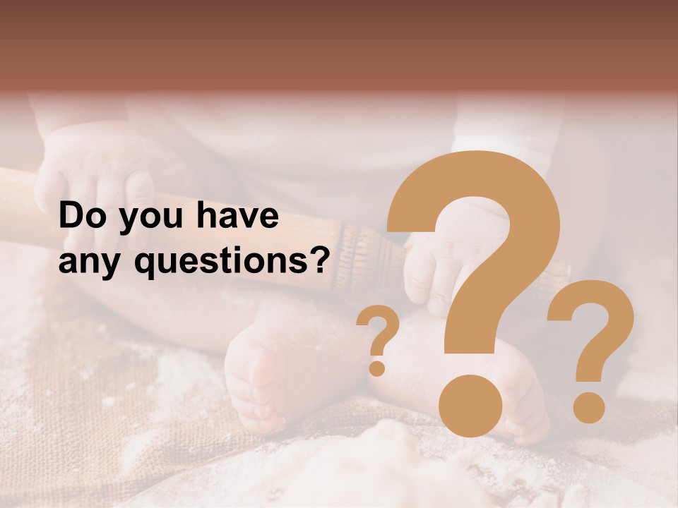 A Baby Holding A Rolling Pin On Top Of A Table PowerPoint Template