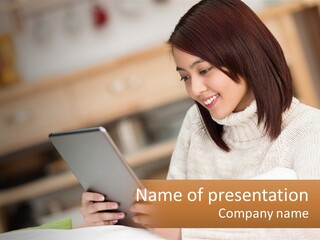 A Woman Sitting At A Table Using A Tablet Computer PowerPoint Template